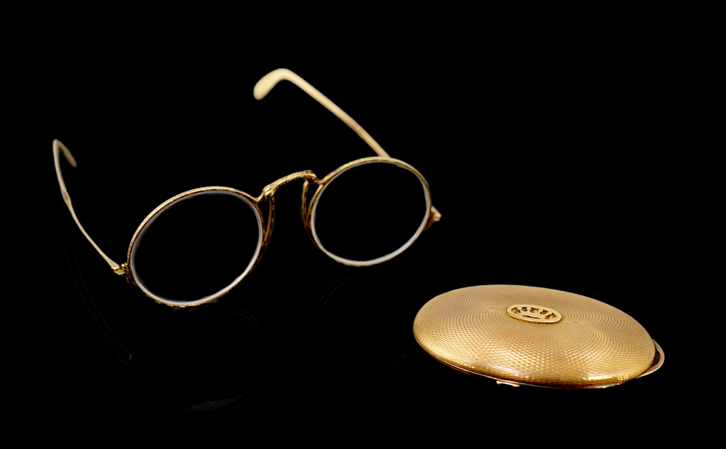 A pair of engraved gold mounted spectacles